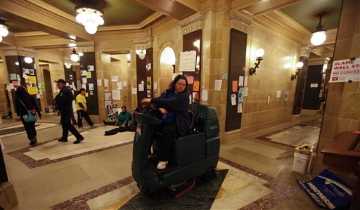 A custodian washes the floor of the at the state Capitol in Madison, Wis., Sunday, Feb. 27, 2011., on the 13th day of protests over the governor's proposed budget. (AP Photo/Andy Manis) (AP)