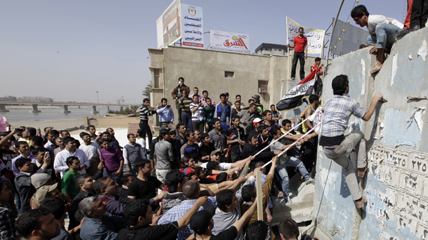 Protesters pull down a concrete wall in Baghdad during Iraq's "Day of Rage."