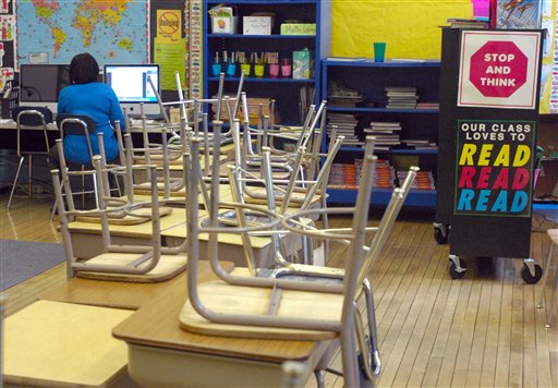 DeLois Bates works in her empty third grade classroom at Janes Elementary School in Racine, Wis., on Thursday Feb. 17, 2011. School districts around Wisconsin canceled classes Thursday as state lawmakers were prepared to pass a momentous bill that would strip government workers of nearly all collective bargaining rights. (AP Photo/Journal Times, Mark Hertzberg) (AP)