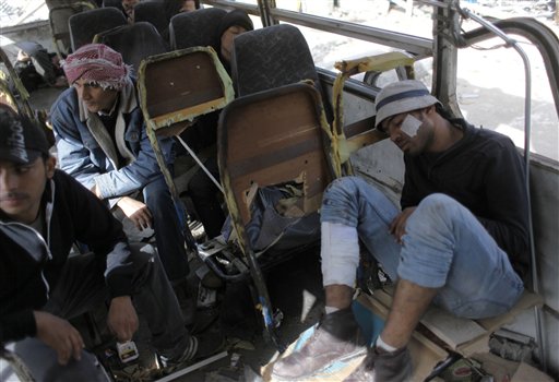 Anti-government protestors rest in a burnt out vehicle in Tahrir Square, Cairo, Egypt, Friday, Feb. 4, 2011. The Egyptian military guarded thousands of protesters pouring into Cairo's main square on Friday in an attempt to drive out President Hosni Mubarak after a week and half of pro-democracy demonstrations. (AP Photo/Emilion Morenatti) (AP)