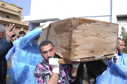 Men carry a coffin at Al-Jalaa hospital in Benghazi, Libya on Monday, Feb. 21, 2011. Libyan protesters celebrated in the streets of Benghazi on Monday, claiming control of the country's second largest city after bloody fighting, and anti-government unrest spread to the capital with clashes in Tripoli's main square for the first time. (AP Photo/Alaguri) (AP)
