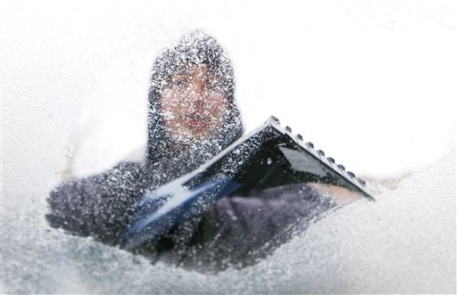 Lydia Vasquez scrapes ice from the windshield of her automobile in Denver on Monday, Jan. 31, 2011.  A front moved through the state early Monday morning bringing with it freezing rain, snow and cold. (AP Photo/Ed Andrieski) (AP)