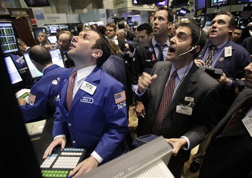 FILE - In this May 25, 2010 file photo, specialist Michael Pistillo, left, and traders work on the floor of the New York Stock Exchange. Everyday investors are finally inching back into the stock market. But are they too late?  (AP Photo/Richard Drew, file) (AP)