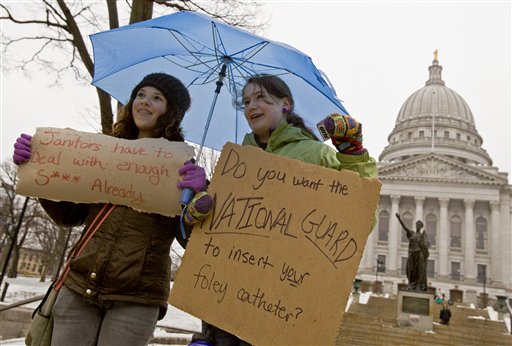 Jane Moran, left, 14, and Emma Rankin-Utevsky, 14, protest outside of at the State Capitol in Madison, Wis., Sunday, Feb. 20, 2011. Opponents to the governor's bill to eliminate collective bargaining rights for many state workers are on their sixth day of protesting. (AP Photo/Andy Manis) (AP)
