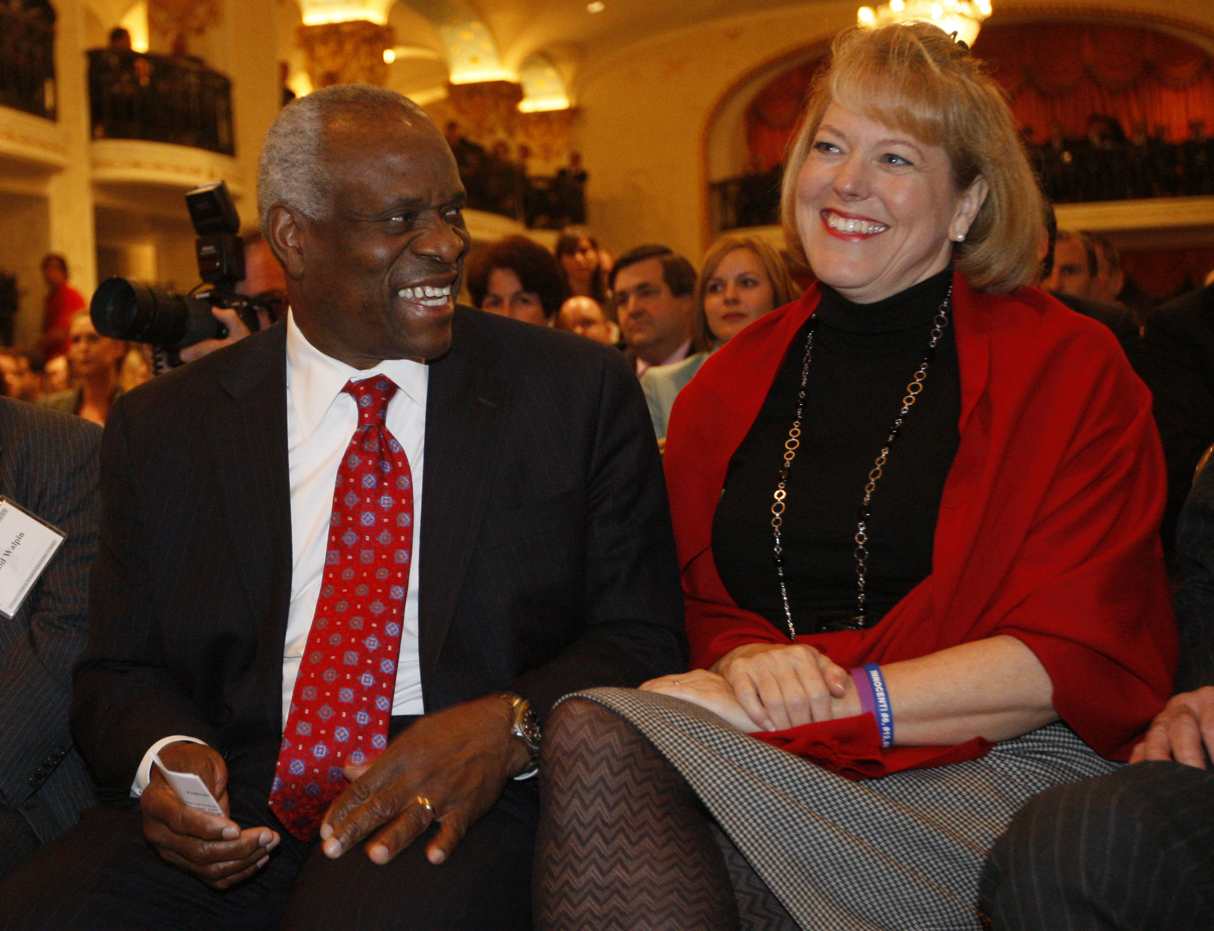 FILE - In this Nov. 15, 2007, photo, Supreme Court Justice Clarence Thomas, left, sits with his wife Virginia Thomas, as he is introduced at the Federalist Society in Washington, where he spoke about his new book and took questions from the audience. Virginia Thomas is asking Anita Hill to apologize for accusing the justice of sexually harassing her, 19 years after Thomas' confirmation hearing spawned a national debate about harassment in the workplace.(AP Photo/Charles Dharapak) (Associated Press)