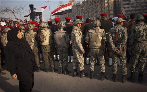 Egyptian army military police and army soldiers form a line to clear protesters from the street and enable vehicles to pass in Tahrir Square in downtown Cairo, Egypt, Sunday, Feb. 13, 2011. Egypt's military is taking down the makeshift tents of protesters who camped out on Tahrir Square in an effort to allow traffic and normal life to return to central Cairo. There were a few verbal altercations between soldiers and protesters Sunday morning as the tents were removed, but the process was generally peaceful.  (AP Photo/Emilio Morenatti) (AP)