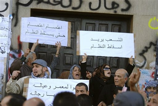 This photograph, obtained by The Associated Press outside Libya and taken by an individual not employed by AP, shows people chanting and holding signs during recent days' unrest in Benghazi, Libya.  Placards in Arabic read at top left "Strike, strike until the fall of the regime", and at top right "The people want to topple the regime".  (AP Photo) EDITOR'S NOTE: THE AP HAS NO WAY OF INDEPENDENTLY VERIFYING THE EXACT CONTENT, LOCATION OR DATE OF THIS IMAGE. (AP)