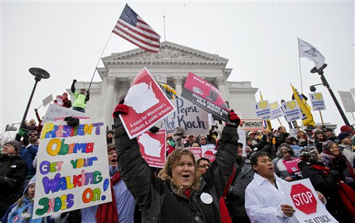 Teacher Kristen Henningfeld, center, of Elk Mound, Wis., protests on the steps of the state Capitol in Madison, Wis., Saturday, Feb. 26, 2011. Protests to the governor's bill to eliminate collective bargaining rights for many state workers are in their 12th day. (AP Photo/Andy Manis) (AP)