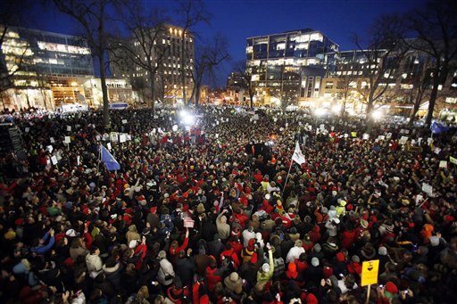 The Rev. Jesse Jackson, near right center of photo, takes the stage amidst tens of thousands of protesters gathered at the State Capitol in Madison, Wis., Friday,  Feb. 18, 2011.   (AP Photo/Wisconsin State Journal, Michael P. King) (AP)