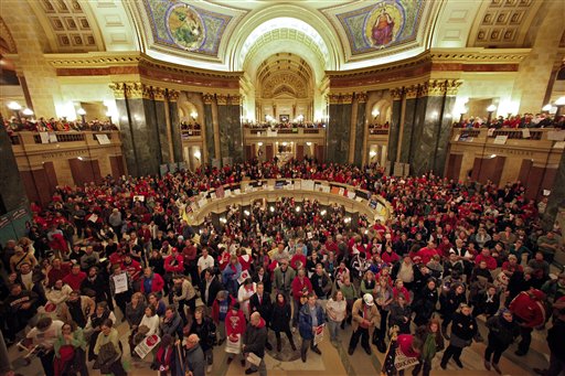 Protestors to Wisconsin Gov. Scott Walker's proposal to eliminate collective bargaining rights for many state workers listen in the rotunda at the State Capitol in Madison, Wis., Wednesday, Feb. 16, 2011, to testimony during a Joint Finance Committee meeting . (AP Photo/Andy Manis) (AP)
