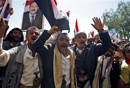 Supporters of the Yemeni government shout slogans as they try to enter Sanaa University where anti-government protestors gather, in Sanaa, Yemen, Wednesday, Feb. 16, 2011. Yemen sent 2,000 policemen into the streets of the capital on Wednesday to try to put down days of protests against the president of 32 years, a key U.S. ally in battling al-Qaida.The policemen, including plainclothes officers, fired in the air and blocked thousands of students at Sanaa University from joining thousands of other protesters elsewhere in the capital who were holding a sixth straight day of demonstrations. (AP Photo/Hani Mohammed) (AP)