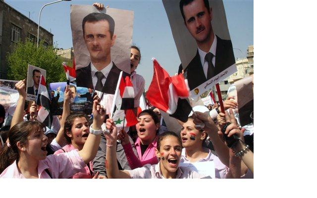 Young pro-Syrian President Bashar Assad protesters, shout pro-Assad slogans as they demonstrate to show their support for him.