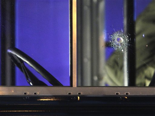 A bullet hole is seen in the driver's window as the bus is towed away after a gunman fired shots at U.S. soldiers on the bus outside Frankfurt airport, Germany, Wednesday, March 2, 2011 killing two airmen and wounding two before being taken into custody. (AP Photo/Michael Probst) (AP)
