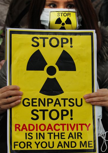 A protester holds a placard during an antinuclear rally in Tokyo Sunday, March 27, 2011. Leaked water in Unit 2 of the Fukushima Dai-ichi plant measured 10 million times higher than usual radioactivity levels when the reactor is operating normally, Tokyo Electric Power Co. spokesman Takashi Kurita told reporters in Tokyo. "Genpatsu" on the sign means "nuclear power plant." (AP Photo/Itsuo Inouye) (AP)