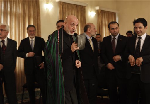 Afghan President Hamid Karzai, center, gestures towards journalists during joint press conference with Croatian counterpart Ivo Josipovic, not in picture, at The Presidential Palace in Kabul , Afghanistan, Saturday, Feb, 19, 2011. Afghanistan's president says any decision on a permanent U.S. military presence in the country must be made by Afghans and take into account the concerns of neighboring countries. (AP Photo/Dar Yasin) (AP)