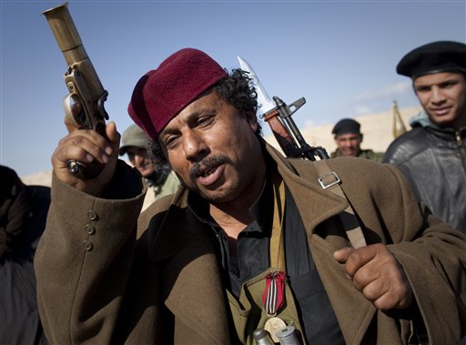 A Libyan rebel gestures before moving closer to the frontline after  Moammar Gadhafi's forces fired on them on the frontline of the outskirts of the city of Ajdabiya, south of Benghazi, eastern Libya, Tuesday, March 22, 2011. (AP Photo/Anja Niedringhaus) (AP)