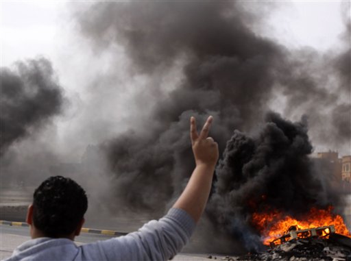 Shiite Bahraini youths burn tires Wednesday, March 16, 2011, near a shopping mall in Malkiya, Bahrain as they awaited government forces they anticipated would roll into their Shiite Muslim village southwest of the capital of Manama. They said they tried to get to Manama to join anti-government protesters under attack there but found all ways in to the capital closed. (AP Photo/Hasan Jamali) (AP)