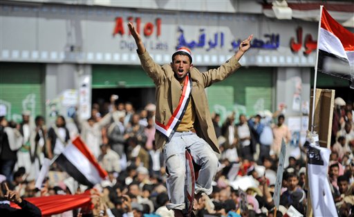 An anti-government protestor sitting on a traffic sign reacts as the bodies of  demonstrators who were killed on Friday's clashes with Yemeni security forces, arrive during their funeral procession in Sanaa,Yemen, Sunday, March 20, 2011. The Yemeni president's own tribe has called on him to step down after a deadly crackdown on protesters, robbing the embattled U.S.-backed leader of vital support in a society dominated by blood ties. (AP Photo/Hani Mohammed) (AP)