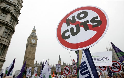 Back-dropped by Big Ben, demonstrators against the coalition government's spending cuts march in London, Saturday, March 26, 2011.  Tens of thousands of mostly peaceful demonstrators streamed into central London on Saturday to march against government budget cuts, with a small breakaway group smashing its way into a bank, breaking windows and spray painting logos on the walls . (AP Photo/Akira Suemori) (AP)