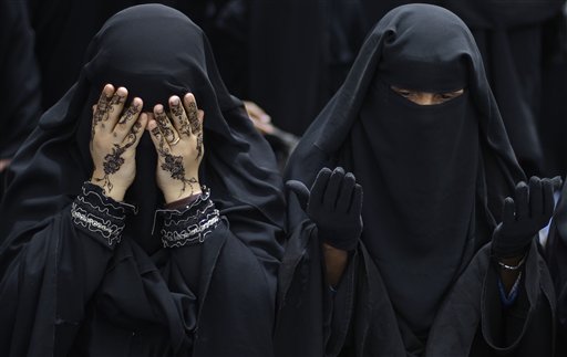 Female anti-government protestors react while chanting prayers during a demonstration demanding the resignation of Yemeni President Ali Abdullah Saleh, in Sanaa,Yemen, Sunday, March 27, 2011. Islamic militants seized control of a weapons factory and a nearby town in Yemen's south Sunday, said a witness and security officials, as political turmoil around the country causes security to unravel. (AP Photo/Muhammed Muheisen) (AP)