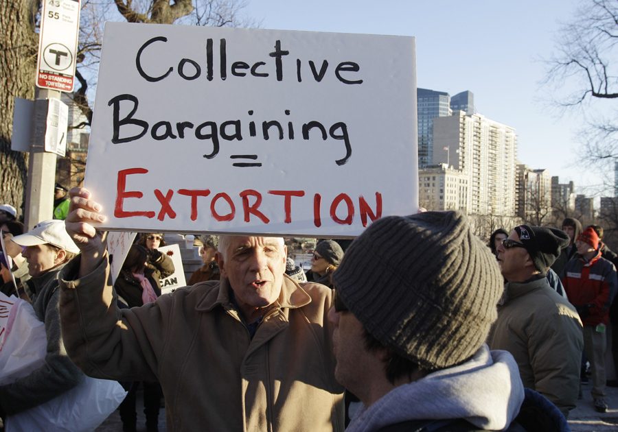 Charles Chase, a retired teacher wiuth 50 years experience from Fall River, Mass., stands againt Wisconsin workers during a Massachusetts Teachers Association "Stand Up for Wisconsin Workers" rally outside the Statehouse in Boston, Tuesday afternoon Feb. 22, 2011. (AP Photo/Stephan Savoia) (Stephan Savoia)
