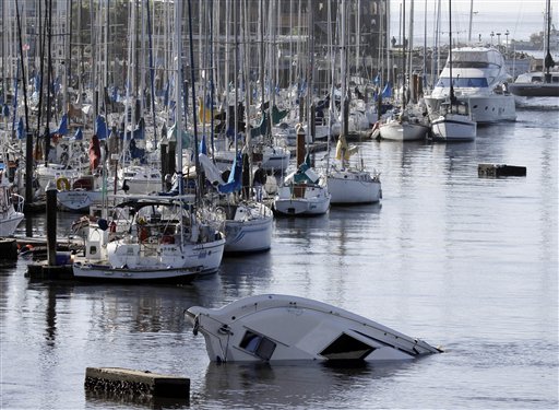 A boat sinks into the ocean in the aftermath of the surge caused by a tsunami on the harbor in Santa Cruz, Calif., Friday, March 11, 2011. A ferocious tsunami unleashed by Japan's biggest recorded earthquake slammed into its eastern coast Friday, killing hundreds of people as it carried away ships, cars and homes, and triggered widespread fires that burned out of control. Hours later, the waves washed ashore on Hawaii and the U.S. West coast, where evacuations were ordered from California to Washington but little damage was reported. The entire Pacific had been put on alert _ including coastal areas of South America, Canada and Alaska _ but waves were not as bad as expected. (AP Photo/Marcio Jose Sanchez) (AP)