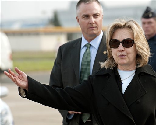 US Secretary of State Hillary Clinton gestures after arriving Monday, March 14, 2011, at Le Bourget airport, north of Paris. U.S. Secretary of State Hillary Rodham Clinton is in Paris for talks with European and other leaders on the crisis in Libya. Her talks will include a meeting with Libyan opposition figures as the Obama administration makes its first high-level contact with foes of Moammar Gadhafi. (AP Photo/Paul J Richards, Pool) (AP)