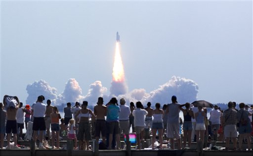 FILE - In this Tuesday, July 26, 2005 file picture, crowds watch as Space Shuttle Discovery lifts off from Kennedy Space Center in Cape Canaveral, Fla. Discovery and seven astronauts blasted into orbit Tuesday on America's first manned space shot since the 2003 Columbia disaster, ending a painful, 2-year shutdown devoted to making the shuttle less risky and NASA more safety-conscious.  (AP Photo/Phil Sandlin) (AP)