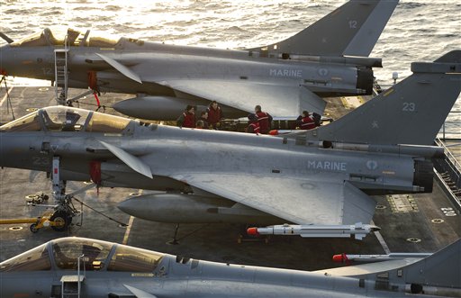 In this Wednesday March 23, 2011 photo provided by the French Army, French Navy Rafale jet fighters on the deck of Charles de Gaulle aircraft carrier in the Mediterranean sea. The international military operation against Libyan leader Moammar Gadhafi's forces may last days or weeks _ but not months, France's foreign minister said Thursday. Alain Juppe also said that he hopes the campaign in Libya serves as a warning to autocratic regimes elsewhere, including in Syria and Saudi Arabia.  (AP Photo/Raphael Martinez) NO SALES (AP)