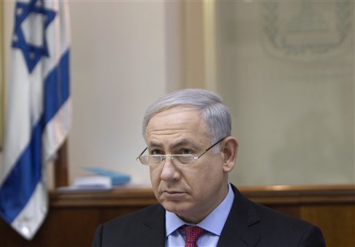 Israel's Prime Minister Benjamin Netanyahu convenes the weekly cabinet meeting in Jerusalem, Sunday, March 13, 2011. Israel said Sunday it has approved hundreds of settler homes after five members of an Israeli family, including three children, were knifed to death as they slept in a West Bank settlement over the weekend. (AP Photo/Ronen Zvulun, Pool) (AP)