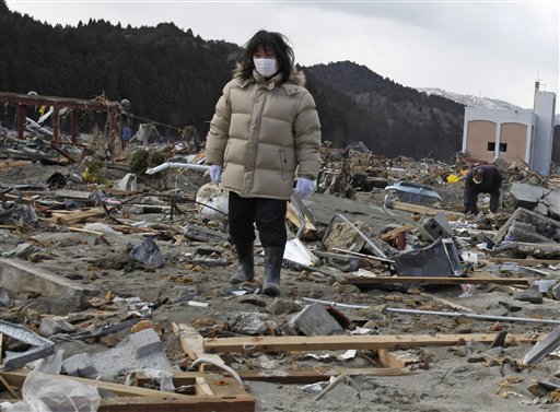 A woman searches for her missing husband through the earthquake and tsunami-hit town of Minamisanriku, Miyagi Prefecture,  Friday, March 18, 2011.  (AP Photo/Shuji Kajiyama) (AP)