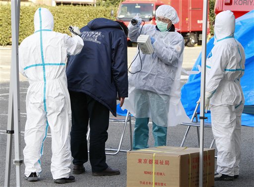 A man is scanned for levels of radiation in Koriyama, Fukushima Prefecture, Japan, Sunday, March 13, 2011. Friday's quake and tsunami damaged two nuclear reactors at a power plant in the prefecture, and at least one of them appeared to be going through a partial meltdown, raising fears of a radiation leak. (AP Photo/Mark Baker) (AP)