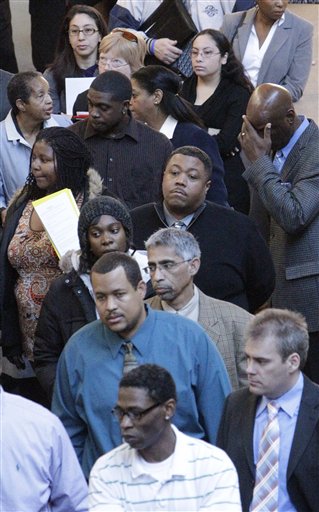 FILE - In this Jan. 26, 2011 file photo, job seekers line up for a job fair at a hotel in Dallas. The number of people applying for unemployment benefits fell last week, after bad weather contributed to a spike in the number of those seeking benefits the previous week. (AP Photo/LM Otero, file) (AP)
