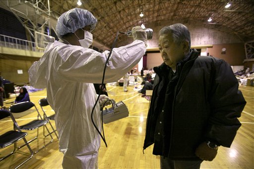 A man is screened for radiation exposure at a shelter after being evacuated from areas around the Fukushima nuclear facilities damaged by last week's major earthquake and following tsunami, Wednesday, March 16, 2011, in Fukushima city, Fukushima prefecture, Japan. (AP Photo/Wally Santana) (AP)
