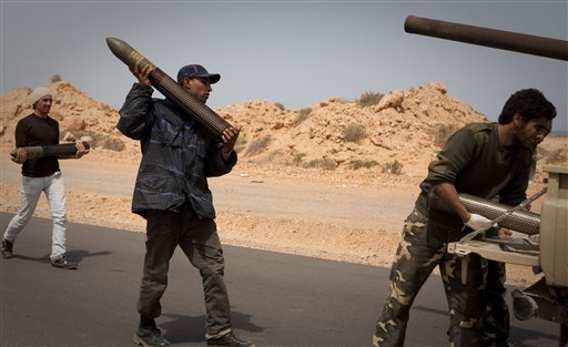 Libyan rebels load ammunition on the frontline outside of Bin Jawaad, 150 km east of Sirte, central Libya, Tuesday, March 29, 2011. Libyan government tanks and rockets blunted a rebel assault on Moammar Gadhafi's hometown of Sirte on Tuesday and drove back the ragtag army of irregulars, even as world leaders prepared to debate the country future in London.  (AP Photo/Anja Niedringhaus) (AP)