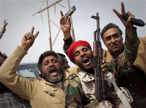 Libyan rebels jubilate on a checkpoint in Al-Egila, east of Ras Lanuf, eastern Libya, Sunday, March 27, 2011. The rebels claim that they have entered Ras Lanuf. (AP Photo/Anja Niedringhaus) (AP)
