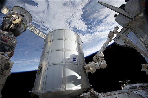 In this image provided by NASA the Italian-built Permanent Multipurpose Module in the grasp of the International Space Station's Canadarm2 is being transferred from space shuttle Discovery's payload bay to be permanently attached to the Earth-facing port of the station's Unity node Tuesday March 1, 2011. Earth's horizon and the blackness of space provide the backdrop for the scene. (AP Photo/NASA) (AP)