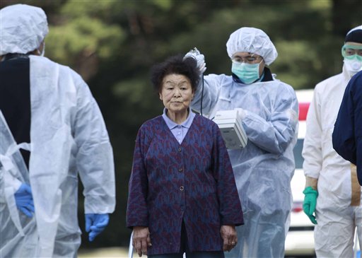 Residents evacuated from areas surrounding the Fukushima nuclear facilities damaged in Friday's massive earthquake, are checked for radiation contamination, Sunday, March 13, 2011, in Koriyama city, Fukushima prefecture, Japan. (AP Photo/Wally Santana) (AP)
