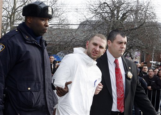 Maksim Gelman, of Brooklyn, who is accused of going on a 28-hour stabbing rampage through New York City, center, is lead by officers outside the 61st Precinct in the Brooklyn borough of New York Sunday, Feb. 13, 2011. (AP Photo/David Karp) (AP)