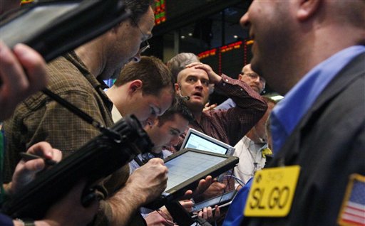 Traders of crude oil and natural gas react during early trading at the New York Mercantile Exchange on Friday, March 11, 2011. The economic fallout from a massive earthquake that struck off the east coast of Japan dipped oil below $100 for the first time this month. (AP Photo/Bebeto Matthews) (AP)