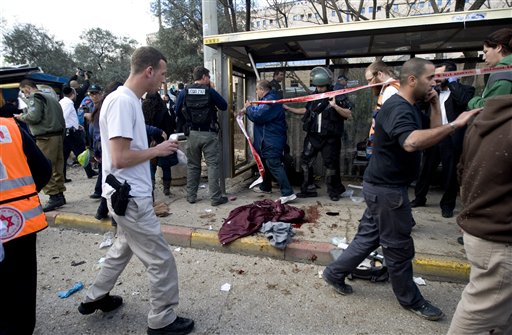 Israel Rescue workers and paramedics work next to a pool of blood following an explosion at a bus stop in Jerusalem, Wednesday, March 23, 2011. A bomb exploded near a crowded bus, wounding at least eight people in what appeared to be the first militant attack in the city in several years. (AP Photo/Ariel Schalit) (AP)