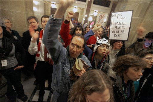 Opponents of Wisconsin Governor Scott Walker's budget repair bill, including C.J. Terrell demonstrate outside the senate parlor at the Wisconsin State Capitol Building as legislators inside voted to move forward on an amended version of the controversial bill Wednesday, March 9, 2011. The new bill removes the fiscal elements from the bill and strips public employees of collective bargaining rights. (AP Photo/Wisconsin State Journal, John Hart) (AP)