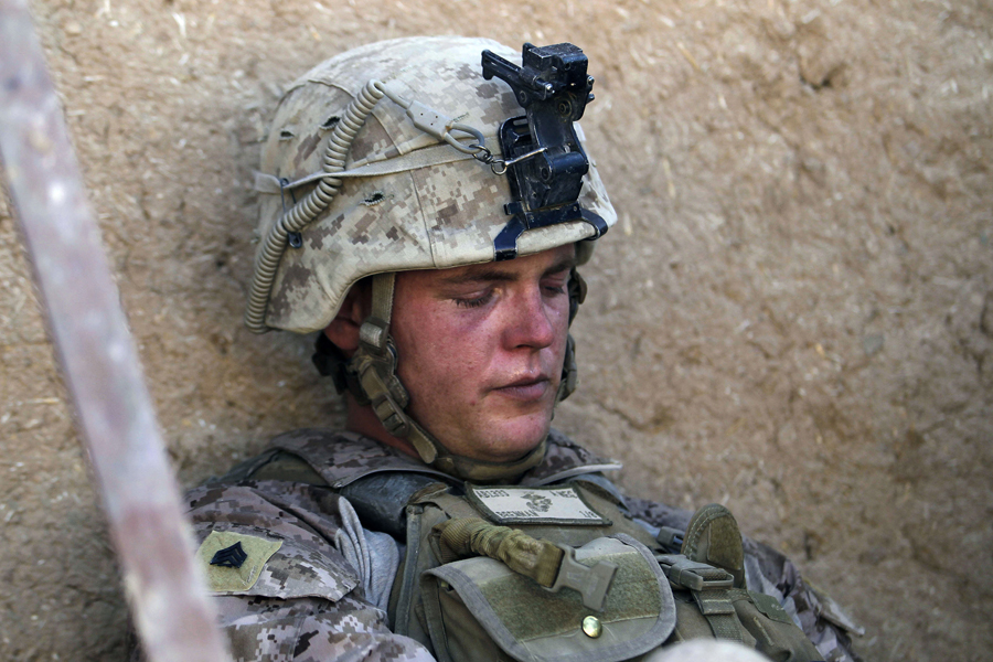 Concussed Sgt. Thomas James Brennan of Randolph, Massachusetts from the 1st Battalion 8th Marines Alpha Company rests in a compound providing cover after a rocket propelled grenade exploded near his position during a battle against Taliban insurgents in the town of Nabuk in southern Afghanistan's Helmand province, November 1, 2010. REUTERS/Finbarr O'Reilly (AFGHANISTAN - Tags: MILITARY CONFLICT) (Â© Finbarr O'reilly / Reuters)