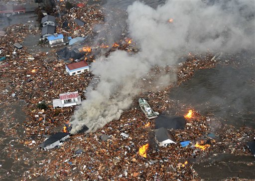 Flames rise from houses and debris half submerged in tsunami in Sendai, Miyagi Prefecture (state) after Japan was struck by a strong earthquake off its northeastern coast Friday, March 11, 2011. (AP Photo/Kyodo News) JAPAN OUT, MANDATORY CREDIT, FOR COMMERCIAL USE ONLY IN NORTH AMERICA (AP)
