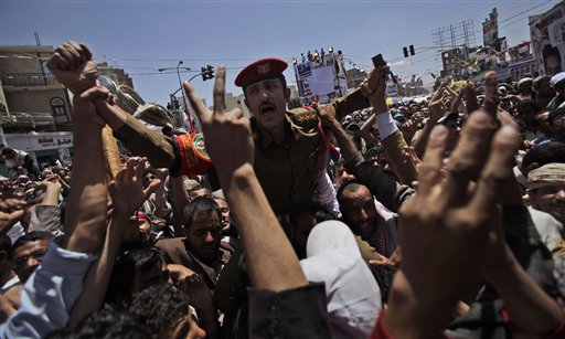 A Yemeni army officer carried by anti-government protestors during a demonstration demanding the resignation of Yemeni President Ali Abdullah Saleh, in Sanaa,Yemen, Wednesday, March 23, 2011. Yemen's parliament enacted sweeping emergency laws Wednesday after the country's embattled president asked for new powers of arrest, detention and censorship to quash a popular uprising demanding his ouster. (AP Photo/Muhammed Muheisen) (AP)
