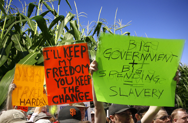 People wave signs at a "tea party" protest on the grounds of the Colorado tate capitol in Denver April 15, 2009. Protests were held in many U.S. cities loosely inspired by the 1773 Boston Tea Party rebellion against British colonial taxes, which helped spark the American revolution. The crowds demonstrated against taxes, government bailouts and U.S. President Barack Obama's budget proposal. REUTERS/Rick Wilking (UNITED STATES POLITICS CONFLICT) (Â© Rick Wilking / Reuters)