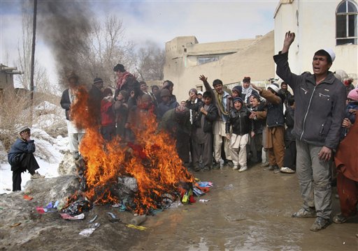 Afghans shout anti US slogans as they burning blankets, clothing and other items, which were distributed by coalition troops in Ghazni west of of Kabul, Afghanistan on Tuesday, March. 1, 2011. Residents in Ghazni burned blankets, clothing and other items that they said coalition troops had distributed in the city on Monday. (AP Photo/Rahmatullah Naikzad) (AP)