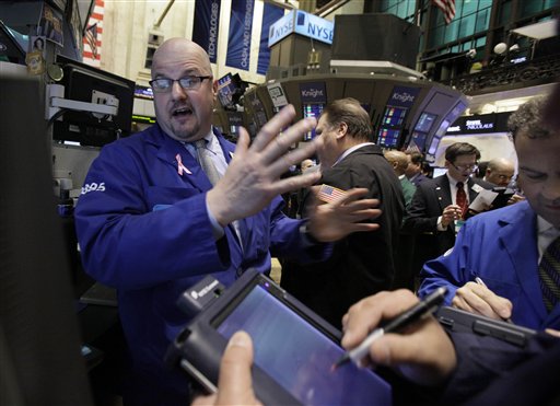 FILE - In this March 2, 2011 file photo, specialist John Urbanowicz, left, works at his post on the floor of the New York Stock Exchange. The stock market's fastest climb in decades reaches the two-year mark Wednesday, March 9, yet investors aren't exuberant. They're cautious and watching their stocks closely for fear that they might experience another meltdown. (AP Photo/Richard Drew, file) (AP)