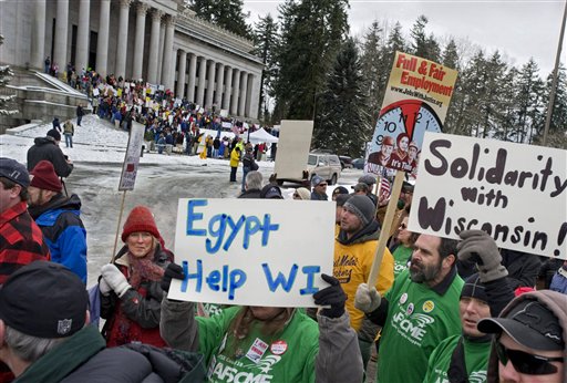 Hundreds of pro-labor union demonstrate across the street  from protesters against unions and in favor of the effort to end the collective bargaining  for Wisconsin government on Saturday, Feb. 26, 2011 in Olympia, Wash.    From unionized firefighters to tea party supporters, two raucous competing rallies over the union fight in Wisconsin drew more than 2,000 people to Washington state's capital despite freezing temperatures Saturday. (AP Photo/The News Tribune, Peter Haley) (AP)