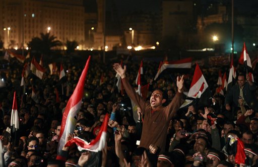 Egyptians celebrate the news of the resignation of President Hosni Mubarak, who handed control of the country to the military, at night in Tahrir Square in downtown Cairo, Egypt Friday, Feb. 11, 2011. (AP Photo/Ben Curtis) (AP)